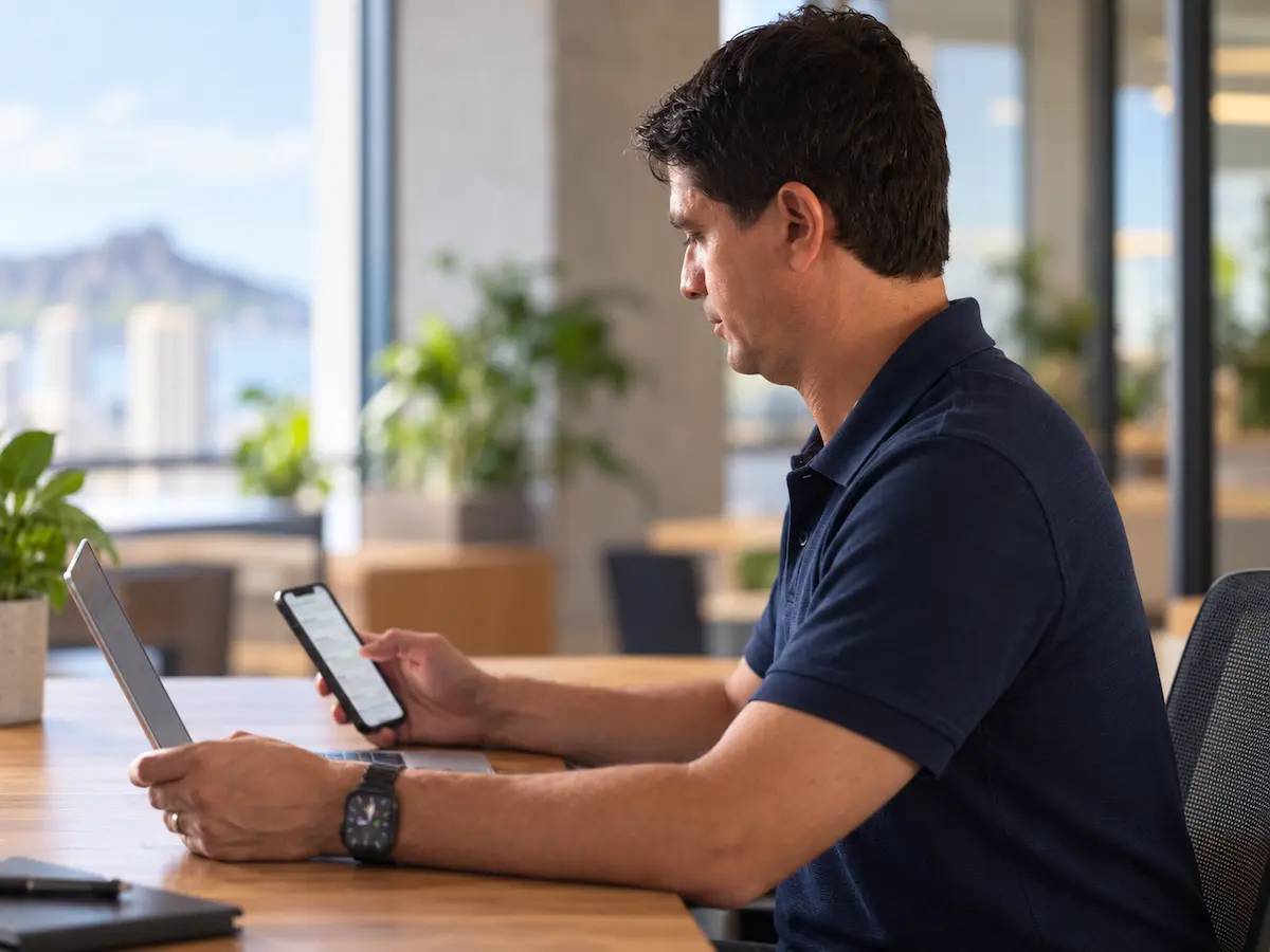 Koolden founder Marcus Mendonca reviewing lead responses on a phone and laptop